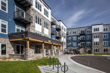 A modern apartment complex with a mix of stone and panel buildings.